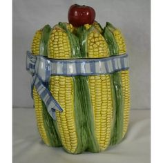 corn on the cob with an apple and ribbon around it