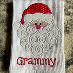 a white towel with a santa clause on it and the word granny written in red