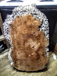 a large piece of metal sitting on top of a wooden table