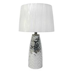 a glass table lamp with a white shade on the base and a silver mosaic design