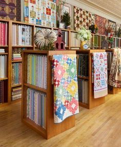 a room filled with lots of books and quilts