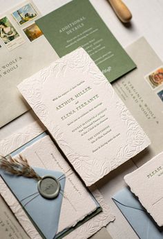 the wedding stationery is laid out on top of each other, including letter and envelopes