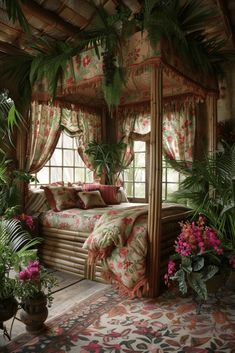 a canopy bed sitting in the middle of a bedroom with lots of plants around it