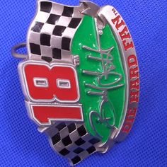 a green and red checkered belt buckle with the words, dale's on it