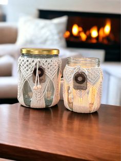 two mason jars sitting on top of a table next to a fireplace in a living room