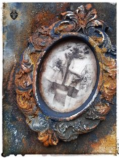 an old rusted metal frame with a painting on it