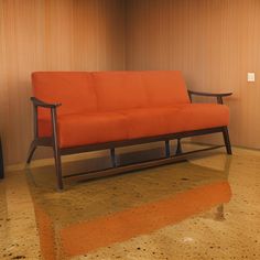 an orange couch sitting on top of a marble floor next to a wall with wood paneling