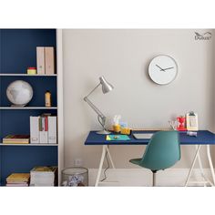 a blue desk with a clock on the wall