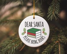 a christmas ornament hanging from a tree with the words dear santa please bring books