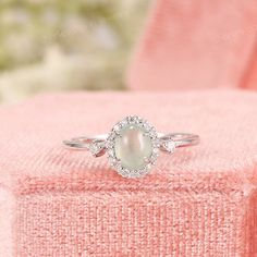 Vintage Ice Mint Green Icy Jadeite Ring, Diamond Halo Settings, Minimalist Jade Engagement Ring, Grade A Burmese Jade, Anniversary Rings ✧･ﾟ: *✧･ﾟ:* Welcome to Charles Davin Jewelry*:･ﾟ･ﾟ✧ ✶Material: 10K/ 14K/ 18K ✶Main Stone: Type A Burmese Jadeite Jade; Approx. 5x6mm ✶Side Stone: Natural Diamonds; Approx. 0.15ct ✶Color: F-G ✶Clarity: SI1 ✶Width of band: 1.5mm ✶Thickness of band: 1.2mm PRODUCTION TIME My team of jewelry artisans and I are ecstatic and cannot wait to share our passion, joy and c Jade Engagement Ring Silver, Green Oval Moonstone Wedding Ring, Oval Green Moonstone Wedding Ring, Elegant Green Moonstone Promise Ring, Jade Wedding Rings For May Birthstone, Jade Engagement Rings, Wedding Jade Silver Rings, Wedding Silver Jade Rings, Jadeite Ring