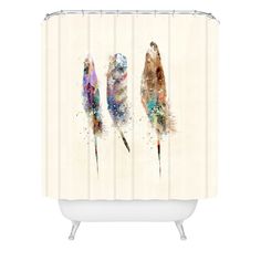 three feathers shower curtain with watercolor paint on it, one is brown and the other is