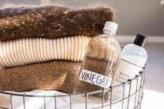 a basket filled with bottles and blankets on top of a table