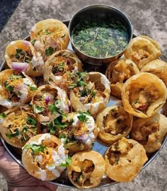 a platter filled with appetizers and dipping sauce