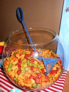 a bowl filled with lots of different types of cereals and toppings on top of a table