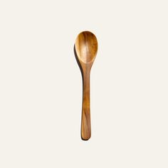 a wooden spoon sitting on top of a white surface