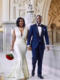 a man and woman in formal wear walking together