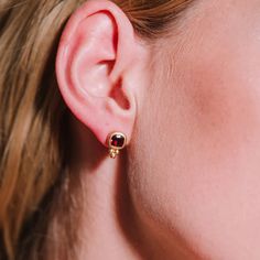 These handcrafted earrings feature a deep red garnet, elegantly set in a rich gold bezel. The delicate gold accents add a playful touch, creating a more casual feel. This piece can easily be combined with a casual oufit or really be accentuated by combining it with a red or black cocktail dress. Sterling silver   Gold vermeil   Garnet  To properly care for your silver jewellery, there are a few important steps you should follow: Clean the jewellery regularly to prevent tarnishing and discoloration. Use a mild detergent or special silver matting sponge. Gently rub the jewellery to remove dirt and oxidation. Avoid gold-plated surfaces so that they do not rub off the gold layer. Avoid contact with chemicals such as perfume, hairspray, cleaning products or chlorinated water. These substances c Red Or Black, August Birthstone Jewelry, July Birthstone Jewelry, Artisan Gift, Gifts For New Mums, Black Cocktail, Zodiac Jewelry, Pearl Jewellery Earrings, Silver Jewelry Handmade