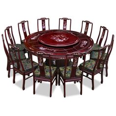 a round dining table with eight chairs and a red center piece on the top is surrounded by green floral upholstered arm chairs