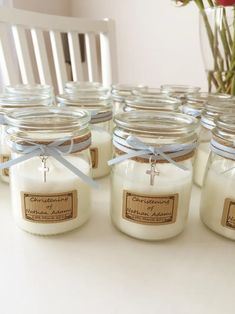 several jars filled with candles sitting on top of a table