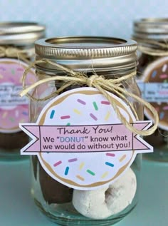 there is a jar with some donuts in it and a thank you tag on the top