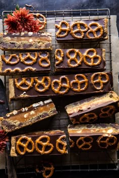 chocolate and pretzels are arranged on top of each other in rows, ready to be eaten