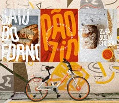 a bike parked in front of a wall with posters on it and the words dad's bread