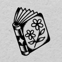 a black and white drawing of a book with flowers on it