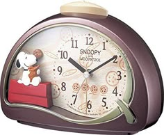 a small clock with a dog on it