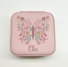 a personalized pink leatherette case with a butterfly and flowers on the front side