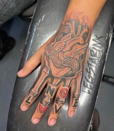 a person with a tattoo on their hand and some tattoos on the other side of his hand