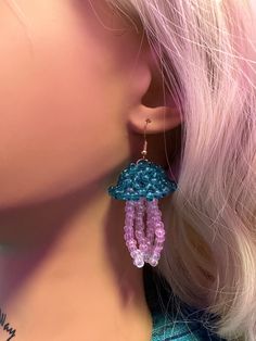 a close up of a person wearing some kind of earring with beads on it