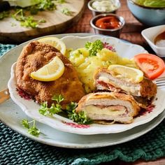 a white plate topped with meat and vegetables