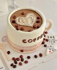 there is a cake that has been decorated with coffee beans and hearts on it, along with other decorations