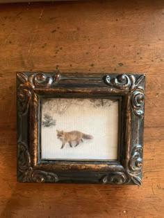 an animal is shown in a frame on the table