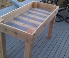 a wooden table sitting on top of a deck