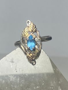 "Black Hills Gold ring leaves long topaz sterling silver women girls Size 8.75 Between a size 8.75 and a size 9 Weight 3.6g Length 1\" Width 3/8\" Thinnest part. 1/8\" Free Shipping & Free Postal Insurance Delivered in a Gift Box If you do not want the ring polished and want to leave the natural patina please let me know at the time of purchase as I do polish rings before I ship rings out. Thanks Free First Class shipping and postal insurance is included. If you want to upgrade to priority kindl Hallmarked Topaz Ring In White Gold, Blue Topaz Hallmarked Ring, Hallmarked Blue Topaz Ring, Fine Jewelry Topaz Ring Stamped 925, Black Hills Gold Rings, Black Hills Gold, Black Hills, Women Girl, Rings Statement