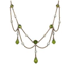 Edwardian 14K Yellow Gold Peridot and Pearl Necklace Set with round and briolette cut peridot and connected by fresh water pearl, measuring 15 inches long and weighing 6.4 dwts. Circa 1900s Fairycore Jewelry, Droplet Necklace, Tiered Necklace, Pearl Necklace Designs, Portland Me, Edwardian Jewelry, Peridot Jewelry, Pearl Necklace Set, Fresh Water Pearl