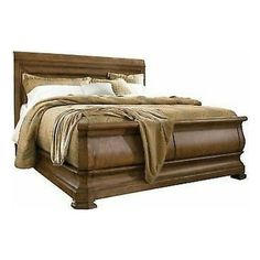 a bed that is made up with brown furniture