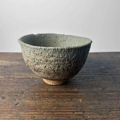 a stone bowl sitting on top of a wooden table