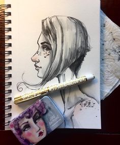 a drawing of a woman's face next to a pencil and eraser