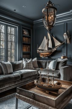 a living room filled with furniture and a sailboat on top of a coffee table