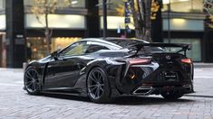 a black sports car parked in front of a building