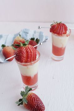 two desserts with strawberries in them on a table