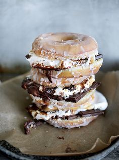 three donuts stacked on top of each other with chocolate and marshmallows