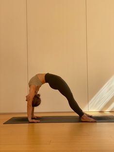 a woman is doing yoga on a mat