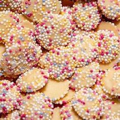 some cookies with sprinkles are on a table