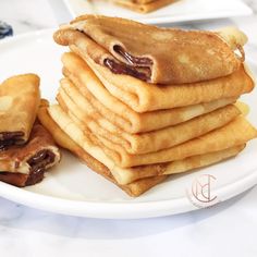 a stack of pancakes sitting on top of a white plate