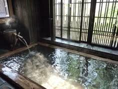 an indoor hot tub with water coming out of it