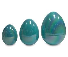 three shiny blue eggs sitting next to each other