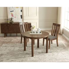 a wooden table with two chairs and a vase on top of it in a living room